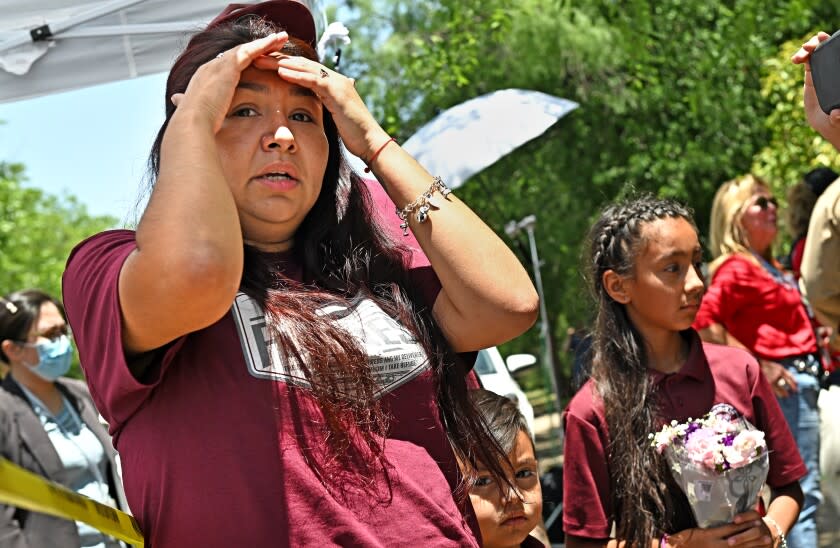 Uvalde, Texas May 25, 2022-A family who lost a child waits to be escorted by police outside Robb Elementary School in Uvalde, Texas Wednesday. (The family did notice any information other than they lost a child) (Wally Skalij/Los Angeles Times)