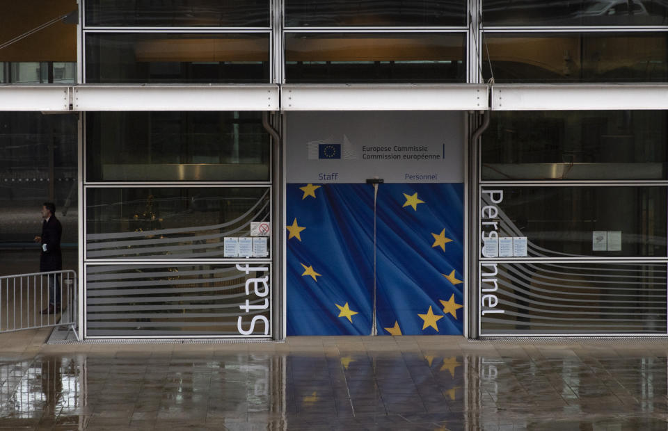 A man takes a break outside of EU headquarters in Brussels, Wednesday, Dec. 23, 2020. France insisted on Wednesday that European Union negotiators should not yield to any time pressure imposed by the Jan. 1 economic cutoff date in the talks with Britain on a trade agreement in the wake of the Brexit divorce, arguing no deal would be better than a bad one. (AP Photo/Virginia Mayo)