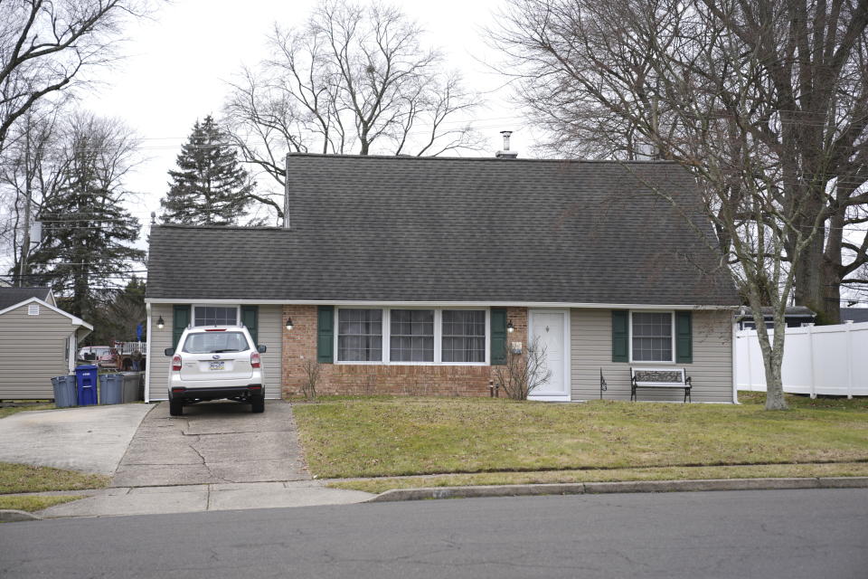 A vehicle is parked in the driveway of a home where a man was found decapitated earlier this week.