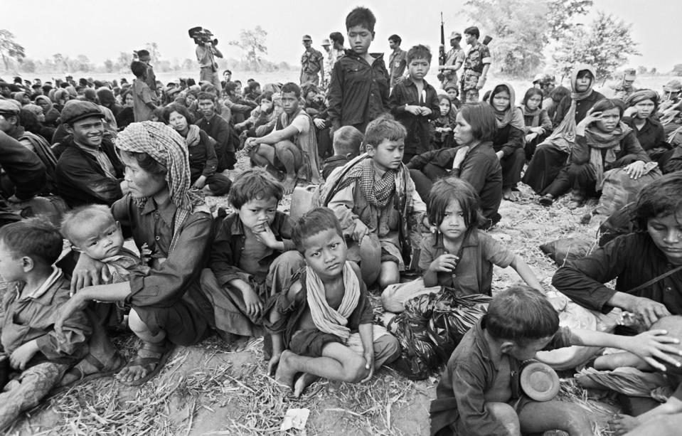 Cambodian youngsters gather in a knot within a crowd of older Khmers including soldiers of the toppled Pol Pot regime, following the group’s escape across the frontier, April 16,1979, in Wong Mon, Thailand. (Photo: Jeff Robbins/AP)