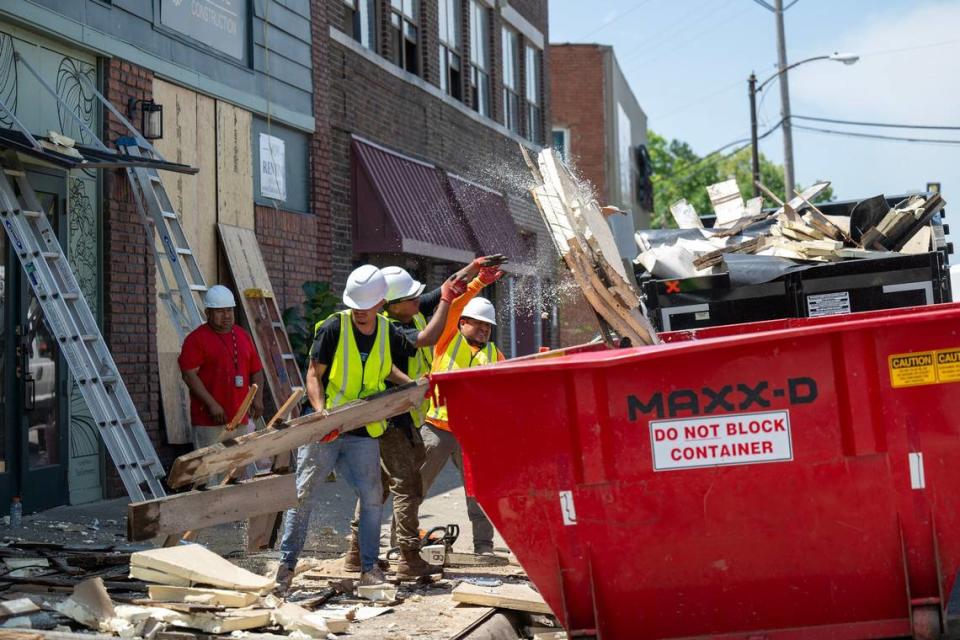 Workers clean up Monday, May 20, 2024, after a powerful thunderstorm Sunday night ripped the roof off the Central Avenue Betterment Association (CABA) building, 1303 Central Ave., in Kansas City, Kansas. The 120 year old building sustained heavy damage.
