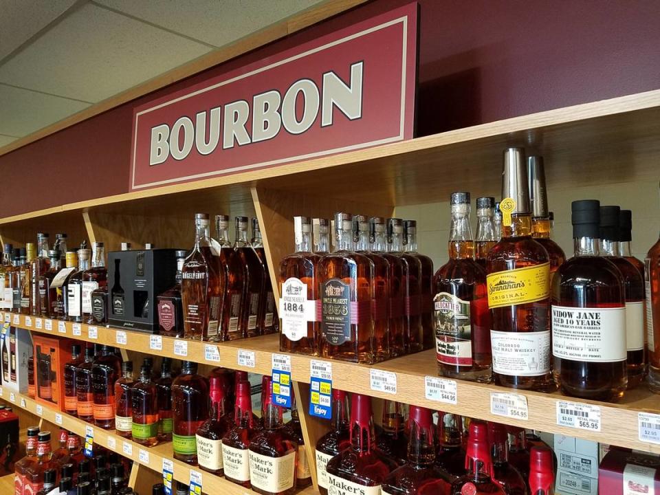 Bourbons line a shelf at a state liquor store in Garden City.
