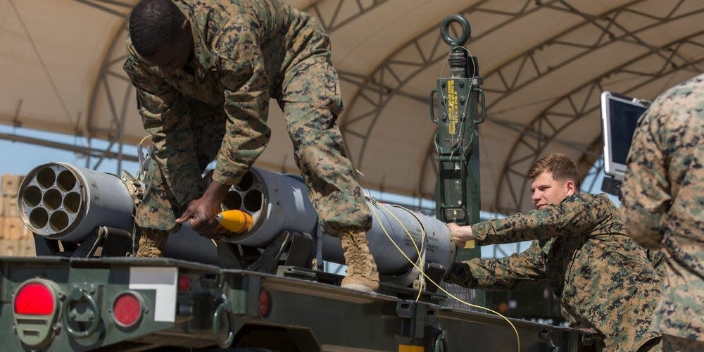 U.S. Marines assigned to Marine Aviation Weapons and Tactics Squadron 1 load a 2.75-inch rocket configured with Advanced Precision Kill Weapon System II, a hydra 70 rocket motor and M282 High Explosive Incendiary Multipurpose Penetrator Warhead into an LAU-68F/A rocket launcher during ordnance building and preparation in support of Weapons and Tactics Instructor course 2-18 at Marine Corps Air Station Yuma, Ariz., March 28.