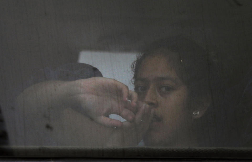 In this May 27, 2019 photo, a migrant looks out of the window of a bus that will be taking her and other migrants to the Siglo XXI migrant detention center in Tapachula, Chiapas state, Mexico, Monday, May 27, 2019. Many migrants who cross into southern Mexico end up in Siglo XXI, Spanish for "21st century," said to be the largest immigration detention center in Latin America. (AP Photo/Marco Ugarte)