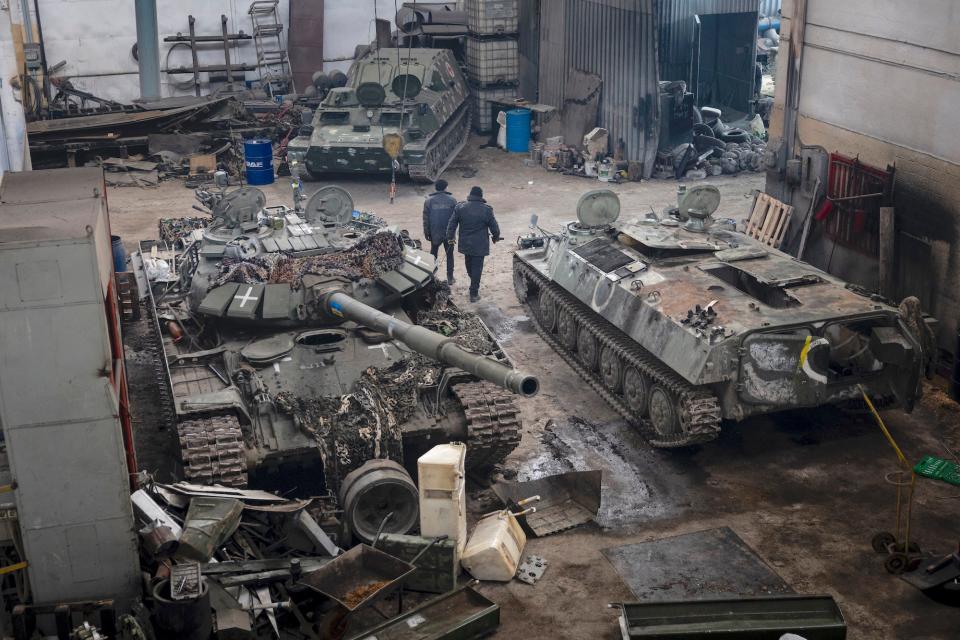 Destroyed tanks in a warehouse.