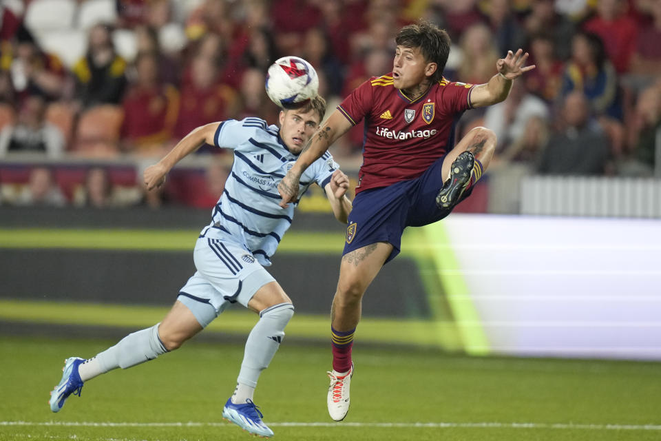 Sporting Kansas City midfielder Jake Davis, left, and and Real Salt Lake midfielder Diego Luna, right, vie for the ball during the first half of an MLS soccer match Saturday, Oct. 7, 2023, in Sandy, Utah. (AP Photo/Rick Bowmer)