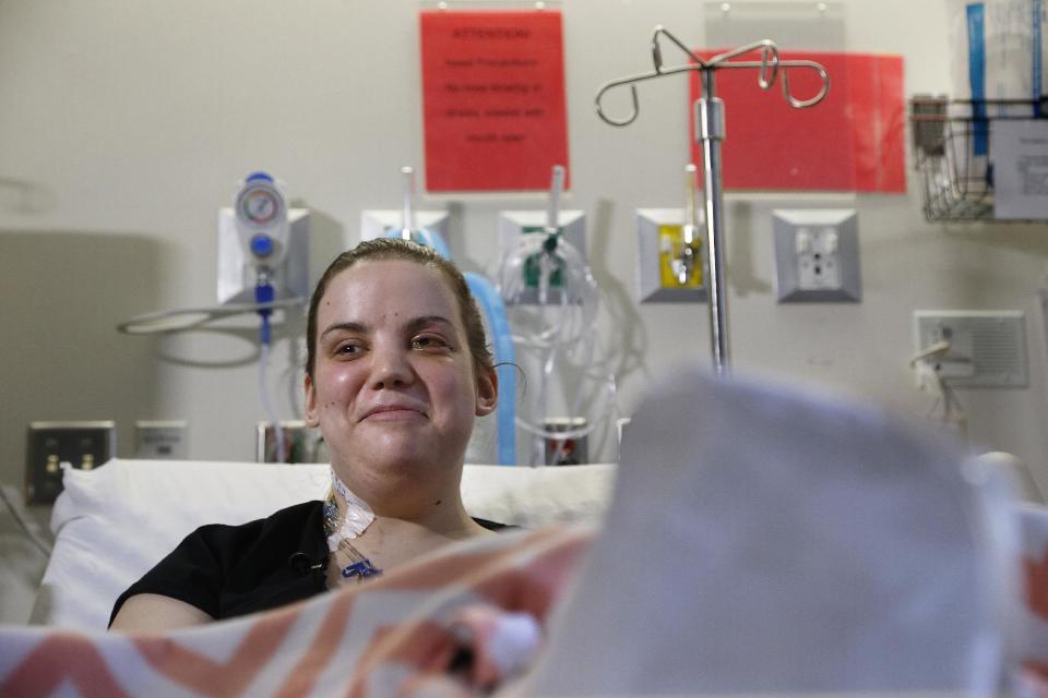 Washington mudslide survivor Amanda Skorjanc, 25, talks to the media while sitting in her hospital bed on Wednesday, April 9, 2014, in Seattle. On March 22, Skorjanic said she was trapped in a pocket formed by her broken couch and pieces of her roof. Skorjanic said that she remembers hearing the voices of several men coming to her aid, she had two broken legs and a broken arm. (AP Photo/The Herald, Dan Bates, Pool)