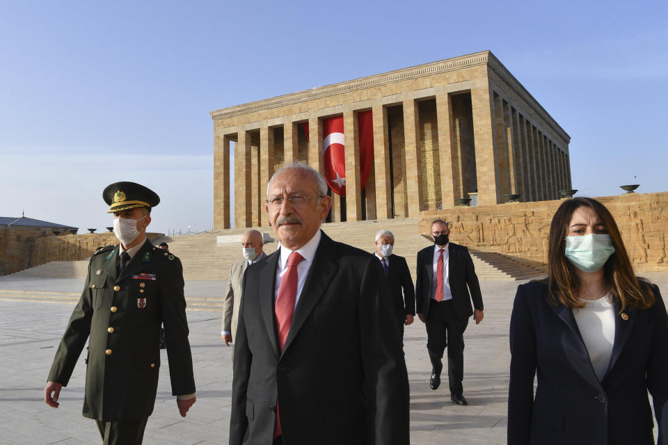 FILE - Kemal Kilicdaroglu, leader of Turkey's main opposition Republican People's Party, CHP, front, is flanked by an army officer and his party members wearing masks to protect themselves against the coronavirus as he visits the mausoleum of Mustafa Kemal Ataturk, the founder of modern Turkey, in Ankara, Turkey, on Tuesday, May 19, 2020. Kilicdaroglu, the main challenger to President Recep Tayyip Erdogan in the May 14 election, cuts a starkly different figure than the incumbent who has led the country for two decades. As the polarizing Erdogan has grown increasingly authoritarian, Kilicdaroglu has a reputation as a bridge builder and vows to restore democracy. (AP Photo, File)