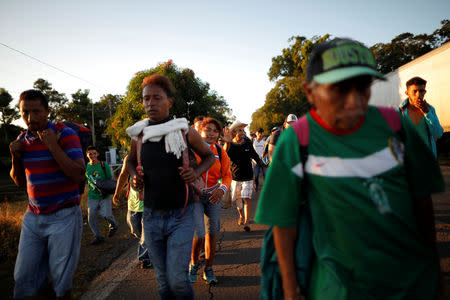 Central American migrants walk along the highway near the border with Guatemala, as they continue their journey trying to reach the U.S., in Tapachula, Mexico October 22, 2018. REUTERS/Ueslei Marcelino