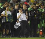 Oregon head coach Mark Helfrich, center, reacts during the second half of the Rose Bowl NCAA college football playoff semifinal against Florida State, Thursday, Jan. 1, 2015, in Pasadena, Calif. (AP Photo/Mark J. Terrill)