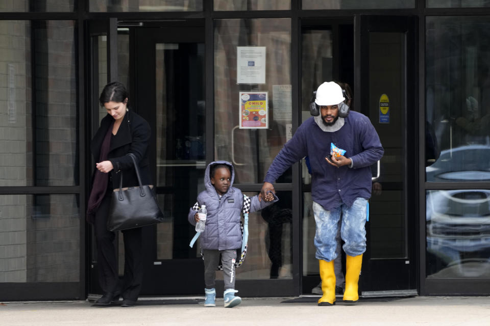 People leave the McCreary Community Building after being reunited following a shooting at Perry High School, Thursday, Jan. 4, 2024, in Perry, Iowa. (AP Photo/Charlie Neibergall)