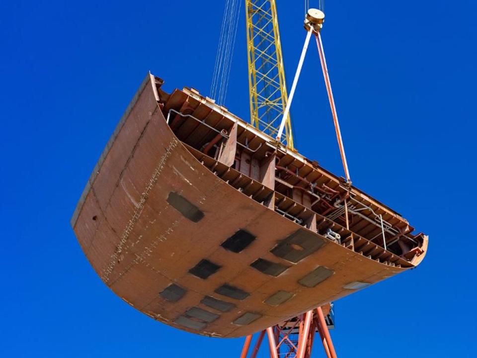 the keel being crane lifted in the air