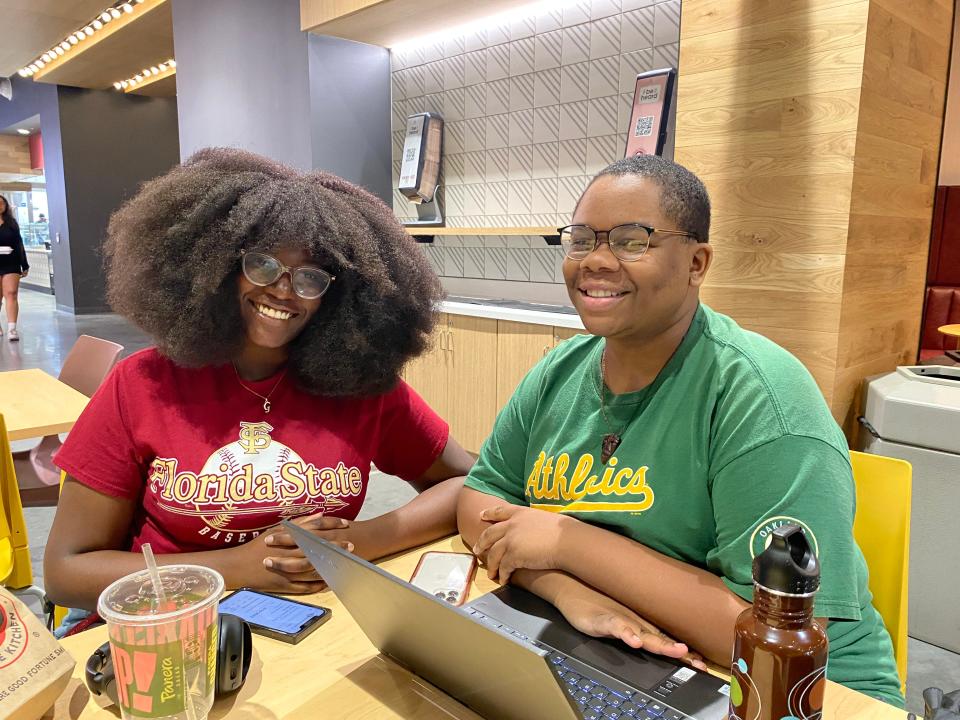 FSU students Gaelle Pierre (left) and Je’Lon Delifus (right) sit together in the university's Student Union building.