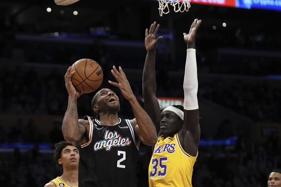 Los Angeles Clippers forward Kawhi Leonard, left, shoots as Los Angeles Lakers forward Wenyen Gabriel defends during the first half of an NBA basketball game Tuesday, Jan. 24, 2023, in Los Angeles. (AP Photo/Mark J. Terrill)