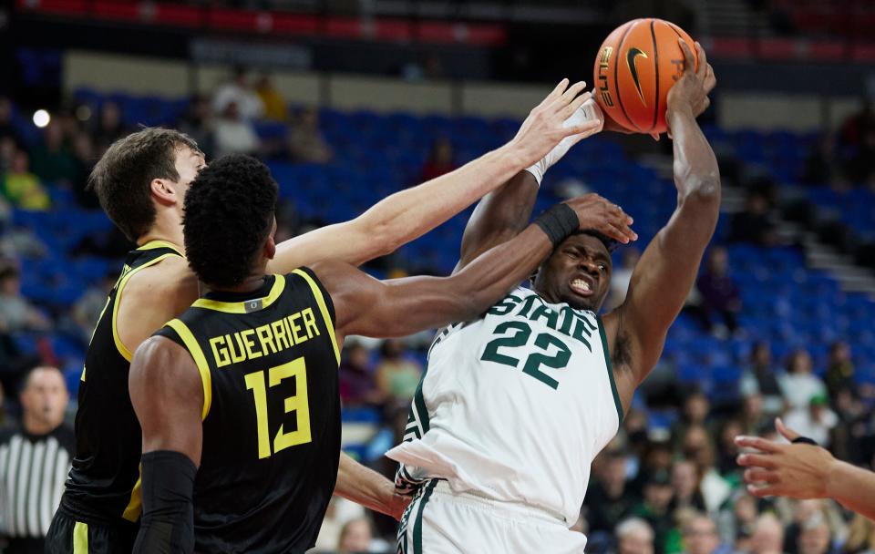 Michigan State center Mady Sissoko, right, is fouled by Oregon forward Quincy Guerrier (13) and center Nate Bittle during the second half of an NCAA college basketball game in the Phil Knight Invitational tournament in Portland, Ore., Friday, Nov. 25, 2022. (AP Photo/Craig Mitchelldyer)