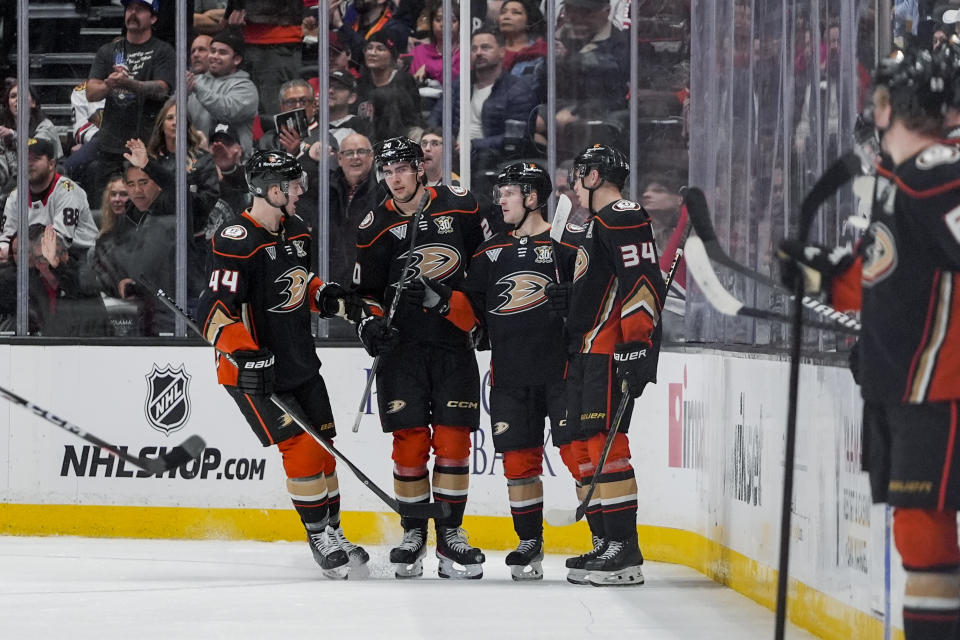 Anaheim Ducks right wing Brett Leason, second from left, celebrates his goal against the Chicago Blackhawks with, from left, left wing Ross Johnston, center Ben Meyers and defenseman Pavel Mintyukov during the second period of an NHL hockey game Thursday, March 21, 2024, in Anaheim, Calif. (AP Photo/Ryan Sun)