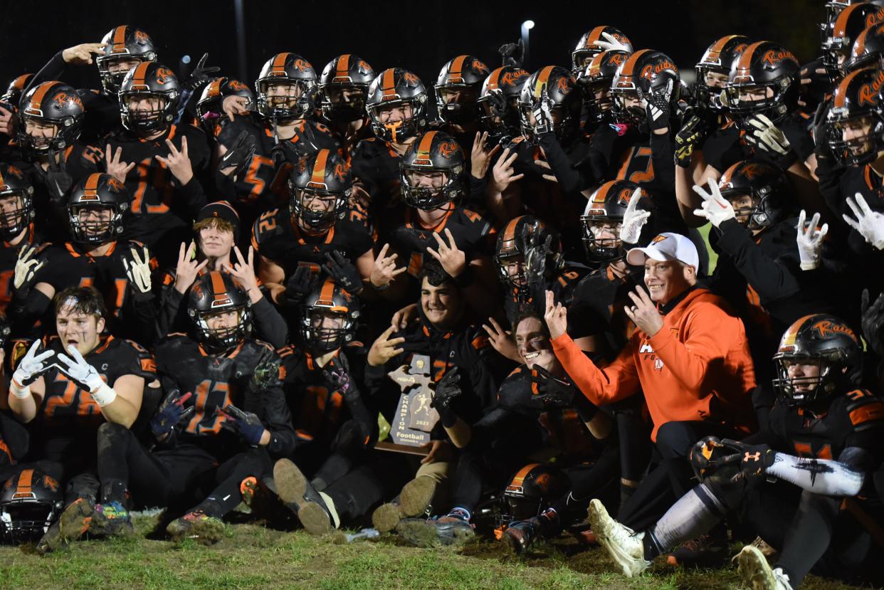 The Almont football team poses for a photo after its 40-38 win over Warren Michigan Collegiate in overtime of a Division 6 district final at Almont High School on Friday.