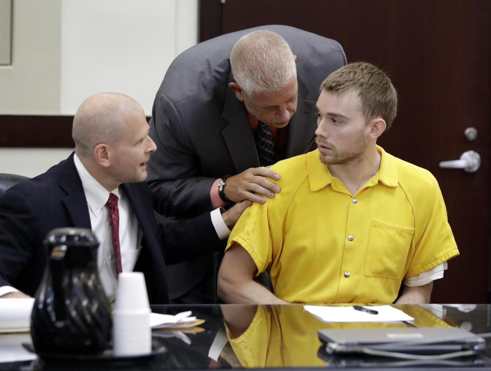 Travis Reinking, right, is quieted by attorney Jon Wing, left, and a courtroom official after Reinking tried to speak during a hearing Wednesday, Aug. 22, 2018, in Nashville, Tenn. Reinking is charged with killing four people during a shooting at a Waffle House restaurant in Nashville in April. (AP Photo/Mark Humphrey)