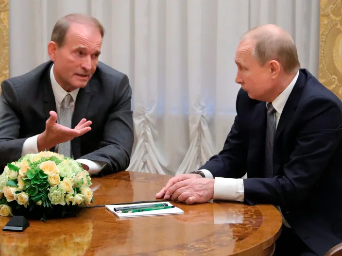 In this Thursday, July 18, 2019 file photo, Russian President Vladimir Putin's close associates, Ukrainian tycoon Viktor Medvedchuk, left, speaks to Russian President Vladimir Putin during their meeting in St. Petersburg, Russia.