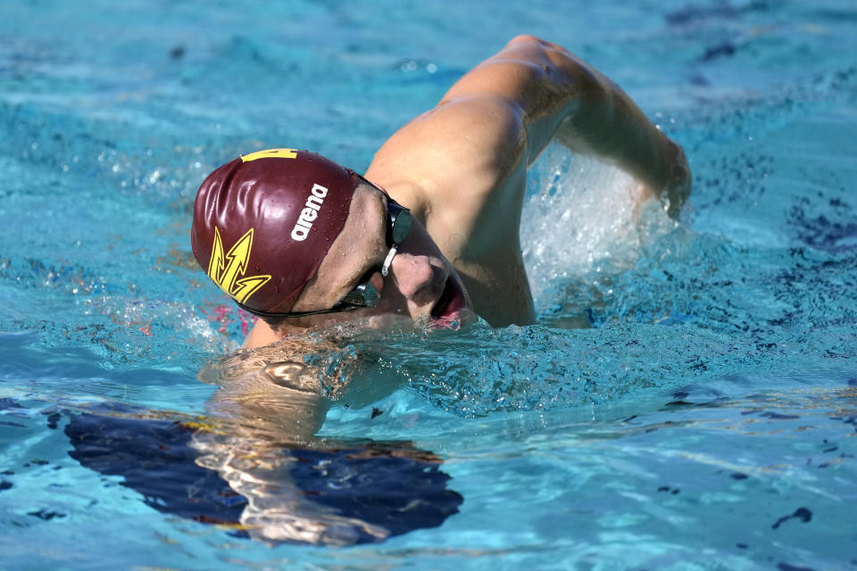 French Olympic swimmer Leon Marchand trains with his Arizona State University teammates, Tuesday, Feb. 13, 2024, in Tempe, Ariz. With family and friends — an entire nation — watching, the individual medley specialist is poised to be one of the premier faces of these Olympics. (AP Photo/Ross D. Franklin)