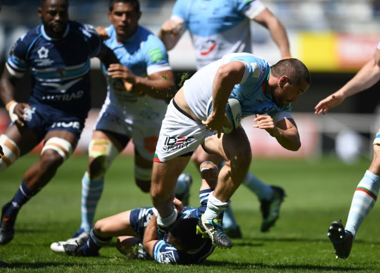 Bayonne's French scrumhalf Bastien Duhalde (R) runs with the ball during the French Top 14 rugby union match between Montpellier and Bayonne on April 16 , 2017 at the Altrad stadium in Montpellier, southern France