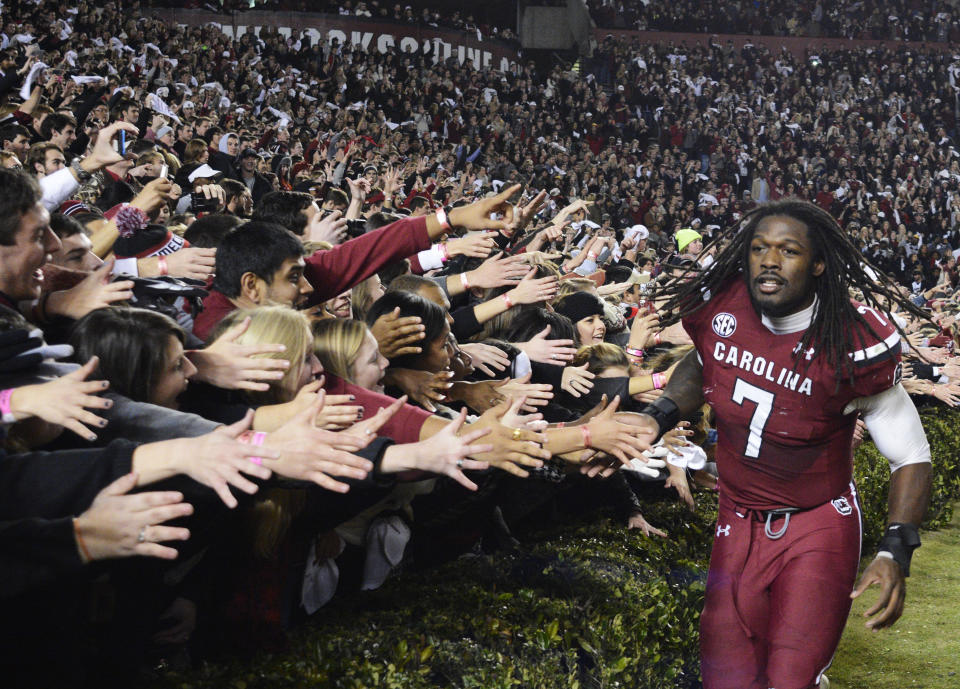 FILE - South Carolina defensive end Jadeveon Clowney (7) celebrates with fans after defeating Clemson 31-17 in an NCAA college football game on Saturday, Nov. 30, 2013, in Columbia, S.C. Cleveland defensive end Jadeveon Clowney will have his college jersey retired at South Carolina's season opener with Georgia State on Sept. 3. The school announced the retirement of Clowney's No. 7 on Friday, Aug. 26, 2022. (AP Photo/Richard Shiro, File)