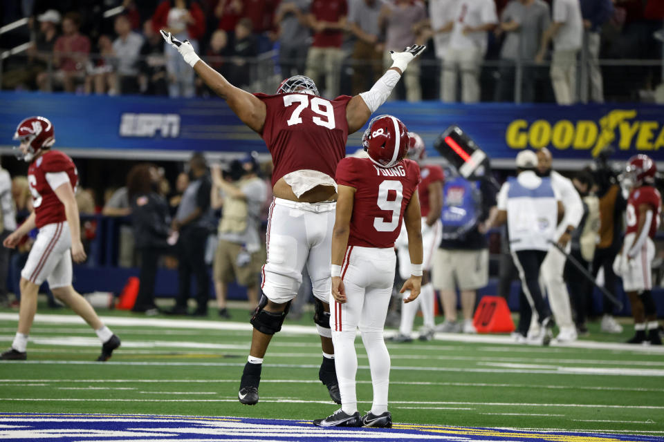 Alabama quarterback Bryce Young (9) celebrates with offensive lineman Chris Owens (79) after throwing a touchdown pass against Cincinnati during the first half of the Cotton Bowl NCAA College Football Playoff semifinal game, Friday, Dec. 31, 2021, in Arlington, Texas. (AP Photo/Michael Ainsworth)