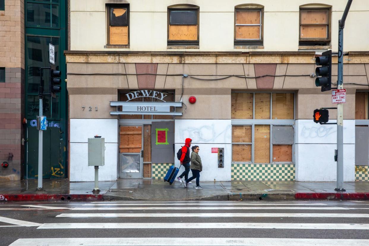 Due to a recent fire, the Dewey Hotel Apartments boarded up and closed.