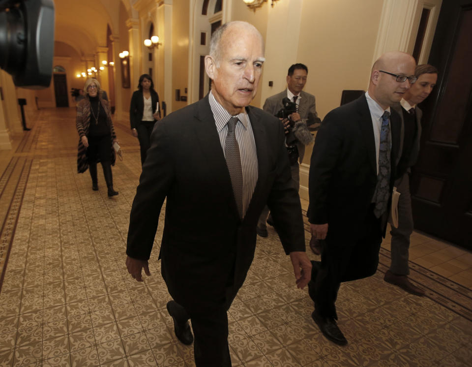 California Gov. Jerry Brown returns to his office after meeting with the Senate Democratic Caucus to urge them to approve a transportation plan, Thursday, April 6, 2017, in Sacramento, Calif. Brown and top legislative leaders pressed all week to convince fellow Democrats to support the measure that would place a $5-billion-a-year boost in California's gas and vehicle taxes to pay for major road repairs. (AP Photo/Rich Pedroncelli)