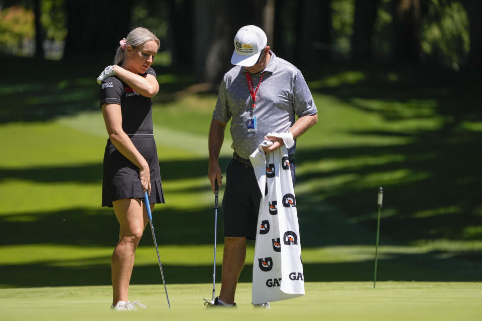 Charley Hull, of England, talks with her caddie on the fourth green during a practice round for the Womens PGA Championship golf tournament at Sahalee Country Club, Wednesday, June 19, 2024, in Sammamish, Wash. (AP Photo/Gerald Herbert)