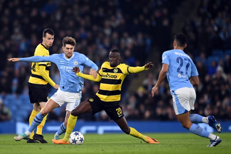 Manchester City defender John Stones (2L) was injured against Young Boys (Oli SCARFF)