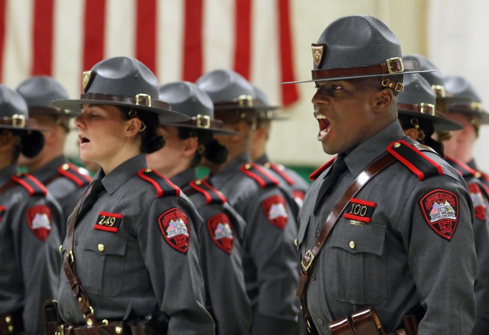 Graduates of the 2019 Rhode Island State Police Training Academy take the oath. The department is boosting pay at its live-in academy and holding practice sessions to help prospective recruits pass the required agility test.