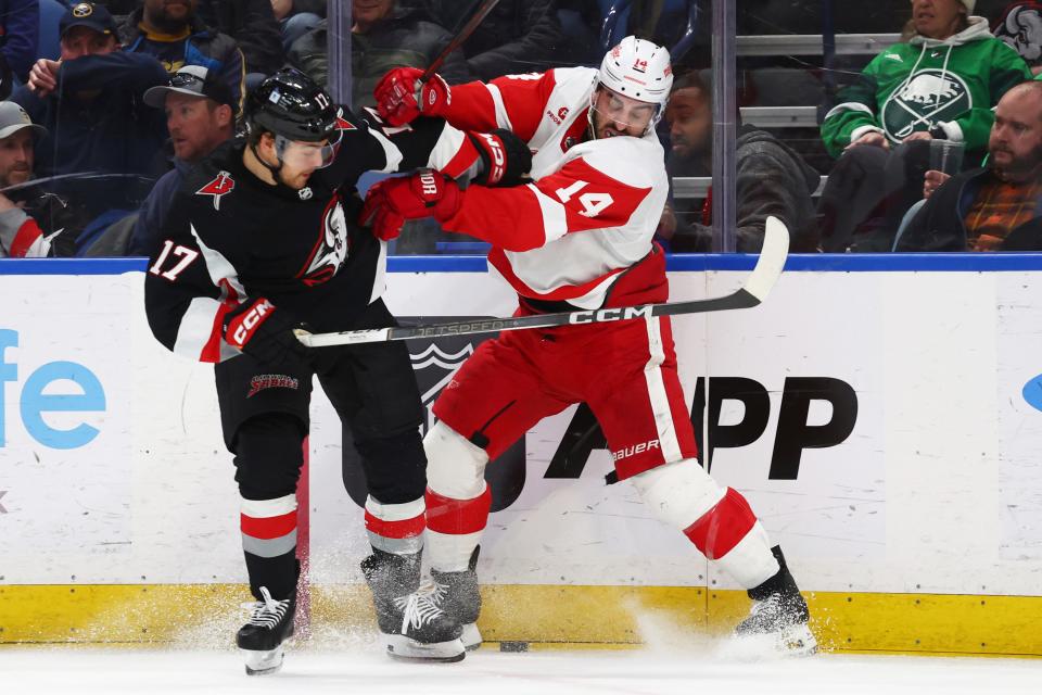 Buffalo Sabres center Tyson Jost (17) and Detroit Red Wings center Robby Fabbri (14) battle for the puck during the second period of an NHL hockey game Tuesday, March 12, 2024, in Buffalo, N.Y. (AP Photo/Jeffrey T. Barnes)