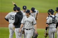 New York Yankees manager Aaron Boone gestures to the bullpen after taking the ball from starting pitcher Gerrit Cole, center, in the sixth inning of a baseball game against the Texas Rangers in Arlington, Texas, Monday, May 17, 2021. (AP Photo/Tony Gutierrez)