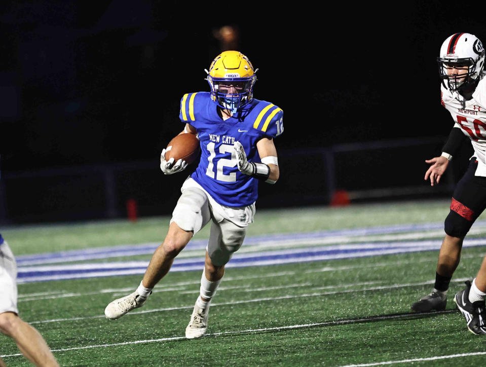 Newport Central Catholic running back Eddie Bivens (12) runs the ball during their 22-6 win over Newport Friday, Oct. 6, 2023.