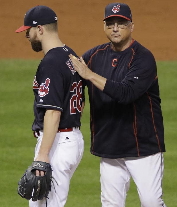 Manager Terry Francona pats starting pitcher Corey Kluber on the back after his gutsy World Series Game 7 performance. (AP)