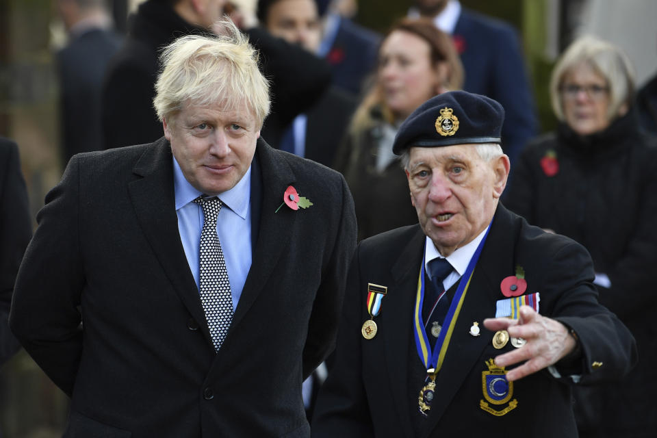 Britain's Prime Minister Boris Johnson, left, attends a remembrance service on Armistice Day, the 101st anniversary of the end of the First World War, in Wolverhampton, England, Monday, Nov. 11, 2019, while on the General Election campaign trail. (Ben Stansall/Pool Photo via AP)
