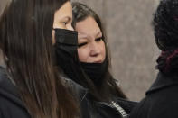 Katie Wright, the mother of Daunte Wright, center, waits in line to go through security with family members as they arrive Wednesday, Dec. 1, 2021 at the Hennepin County Government Center in Minneapolis for the second day of jury selection for former suburban Minneapolis police officer Kim Potter, who says she meant to grab her Taser instead of her handgun when she shot and killed motorist Daunte Wright. (AP Photo/Jim Mone)