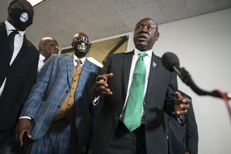 Ben Crump, center, the civil rights attorney representing the family of George Floyd, speaks to reporters after they met with Sen. Cory Booker, D-N.J., about police reform legislation, at the Capitol in Washington, Tuesday, May 25, 2021. (AP Photo/J. Scott Applewhite)