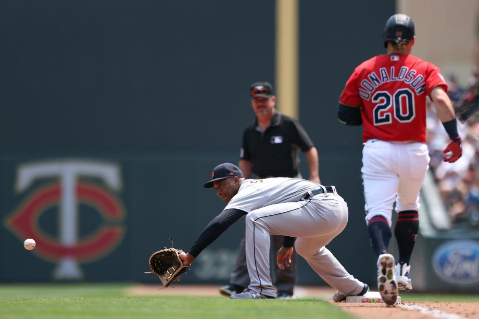 Detroit Tigers' Jonathan Schoop, front left, catches the ball at first base to get out Minnesota Twins' Josh Donaldson (20) after Donaldson hit a ground ball to Tigers third baseman Ian Krol (not shown) during the first inning of a baseball game Sunday, July 11, 2021, in Minneapolis.