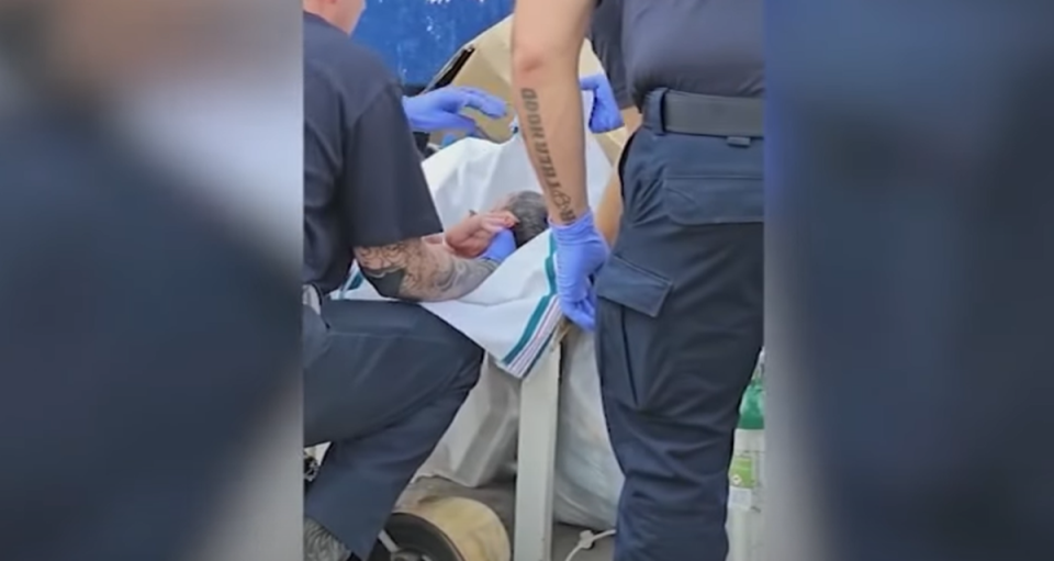EMS rescuing a baby boy from a dumpster in Houston on Sunday. The abandoned healthy baby was taken to hospital, before being transferred to Child Protection Services (ABC13/YouTube)