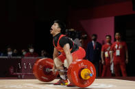 Li Fabin of China competes in the men's 61kg weightlifting event, at the 2020 Summer Olympics, Sunday, July 25, 2021, in Tokyo, Japan. (AP Photo/Luca Bruno)