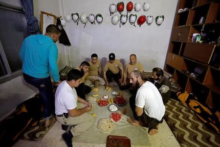 Civil defence members eat iftar in the rebel-controlled area of Maaret al-Numan town, in Idlib province, Syria June 10, 2016. REUTERS/Khalil Ashawi