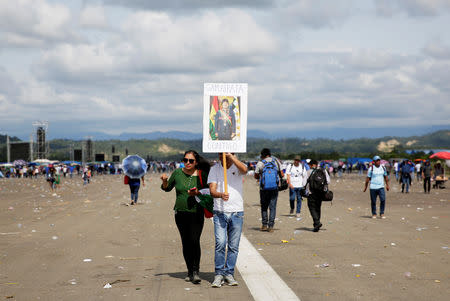 A couple holds a placard depicting Bolivia's President Evo Morales reading "Samaipata is with you", after a rally in Chimore in the Chapare region, Bolivia, May 18, 2019. REUTERS/David Mercado