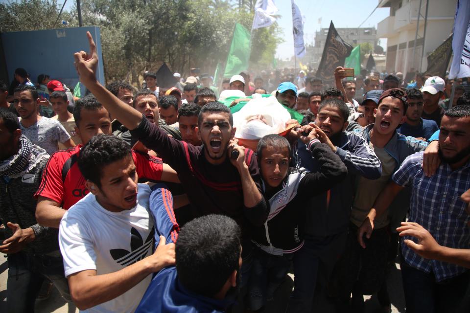 <p>Palestinian mourners carry the dead body of Mukhtar Ebu Hamas, 25, martyred during clashes in Gaza the previous day, during his funeral ceremony in Deir Al Balah, Gaza on May 15, 2018. (Photo: Hassan Jedi/Anadolu Agency/Getty Images) </p>