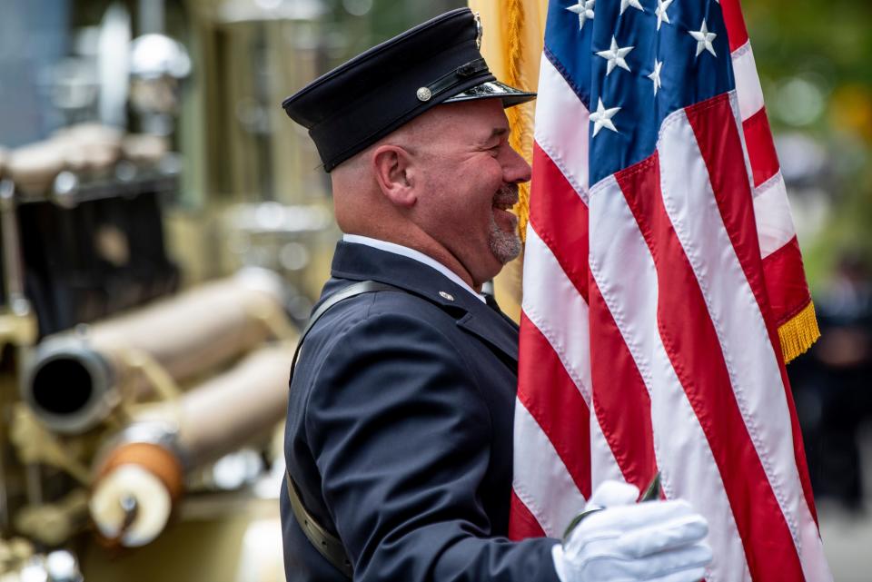 The Boonton Fire Department’s Labor Day Parade is held in Boonton on Saturday September 3, 2022. Jim Vnencak with the Boonton Fire Department smiles as he holds an American flag. 