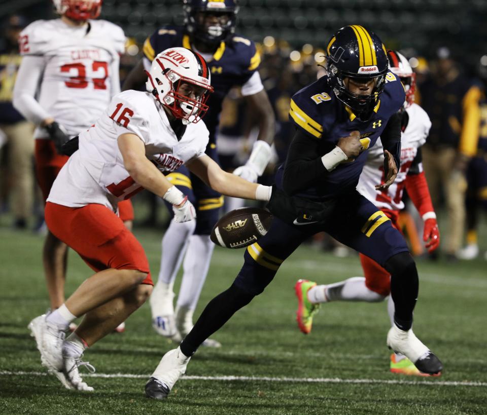 HIlton's Brady Quill's reach causes UPrep's Quarterback Tavion Byrd to fumble the ball as he ran toward the end zone. UPrep's C.J. Robinson Jr. recovered the ball in the end zone giving his team a touchdown.