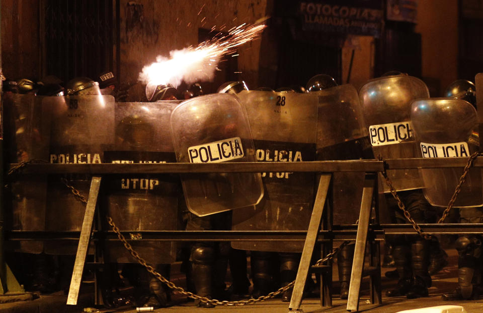 Police fire tear gas at demonstrators during a protest against the reelection of President Evo Morales, in La Paz, Bolivia, Thursday, Nov. 7, 2019. The United Nations on Thursday urged Bolivia's government and opposition to restore "dialogue and peace" after a third person was killed in street clashes that erupted after a disputed presidential election on Oct. 20. (AP Photo/Juan Karita)