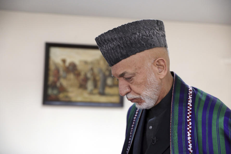 Former Afghan President Hamid Karzai arrives for an interview with the Associated Press in Kabul, Afghanistan, Thursday, March 11, 2021. Afghans are eager for peace and a recently floated U.S. draft for a deal between Taliban insurgents and the Afghan government is the best chance to accelerate stalled peace talks, ex-president Hamid Karzai said in an interview Thursday. (AP Photo/Rahmat Gul)