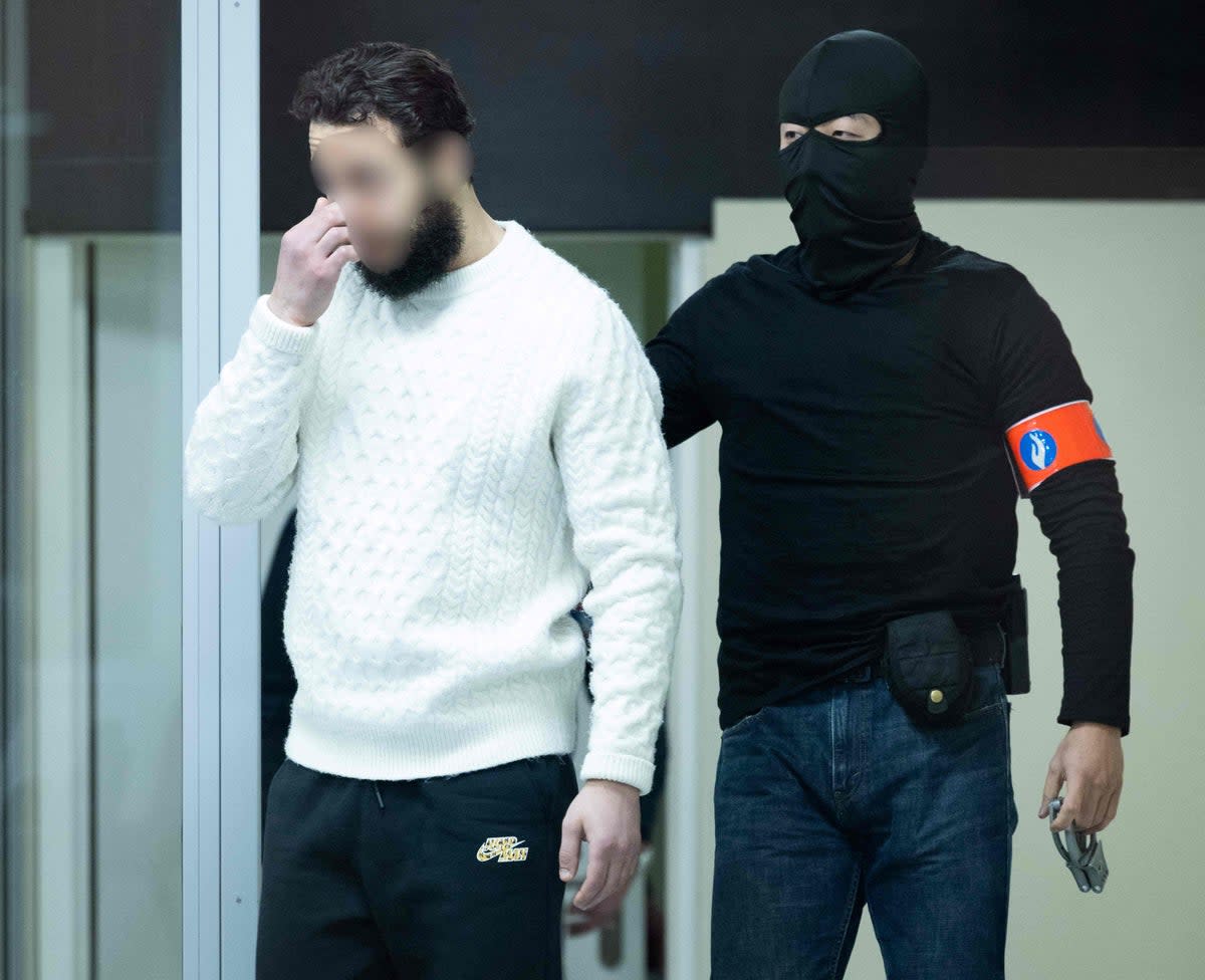 Defendant  Salah Abdeslam arrives under police escort for the trial of alleged jihadists (Belga/AFP via Getty Images)